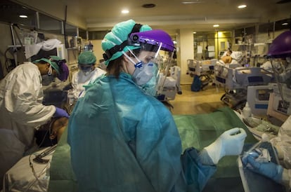 Doctors perform a tracheotomy in a newly opened ICU in a disused area of the hospital.