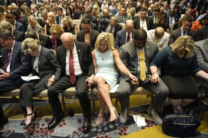 Los representantes Louie Gohmert y Marjorie Taylor Greene, entre otros seguidores de Trump, rezan en la convención de America First Agenda, el martes en Washington.