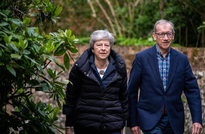 Theresa May y su marido Philip salen del servicio dominical en su parroquia en Sonning.