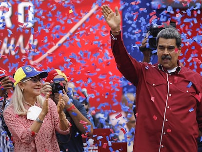 Venezuelan President Nicolas Maduro (R) and his wife Cilia Flores greet workers taking part in a demonstration to commemorate May Day (Labor Day) in Caracas, on May 1, 2023.