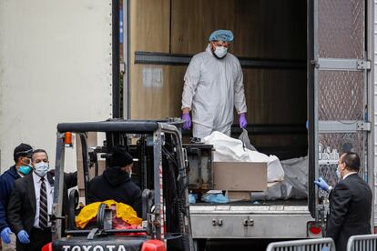 A body wrapped in plastic is loaded onto a refrigerated container truck used as a temporary morgue by medical workers at Brooklyn Hospital Center back in March.