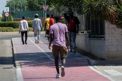 Residentes del CAED de Alcalá de Henares, de vuelta al centro a la hora de la comida, este lunes.