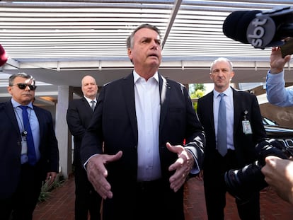 Former Brazilian President Jair Bolsonaro speaks to the press outside his home after Federal Police agents carried out a search and seizure warrant in Brasília, Brazil, on May 3, 2023.