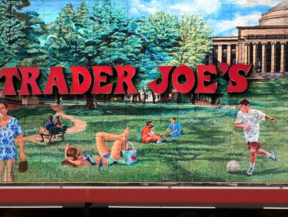 In this Aug. 13, 2019, file photo, Trader Joe's logo hangs on a mural at it's market in Cambridge, Mass.