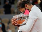 Spain's Rafael Nadal holds the trophy as he celebrates winning the final match of the French Open tennis tournament against Serbia's Novak Djokovic in three sets, 6-0, 6-2, 7-5, at the Roland Garros stadium in Paris, France, Sunday, Oct. 11, 2020. (AP Photo/Christophe Ena)