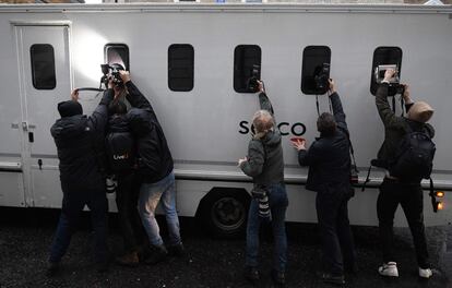 Varios fotógrafos intentan fotografiar a Julian Assange a través de las ventanillas de una furgoneta que llega a la Tribunal de Westminster este viernes.