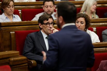 Salvador Illa observa al presidente de la Generalitat, Pere Aragonés durante un pleno del Parlament.