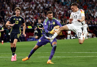 Angus Gunn, portero de Escocia, controla la pelota ante Florian Wirtz de Alemania.