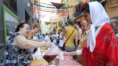 A woman serves sangría during Madrid's San Cayetano festivities.