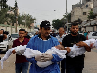 Varios hombres llevan los cuerpos de niños palestinos muertos en los bombardeos israelíes por las calles de Gaza.