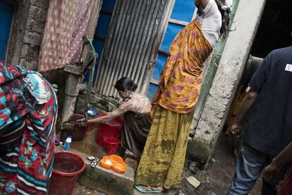 Sin apenas infraestructuras de agua o sanitación, muchas de las mujeres que trabajan en el Town Brothel tienen que bañarse en la calle.