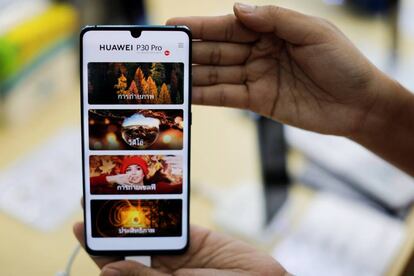 FILE PHOTO:A vendor displays a Huawei P30 Pro mobile at the Mobile Expo in Bangkok