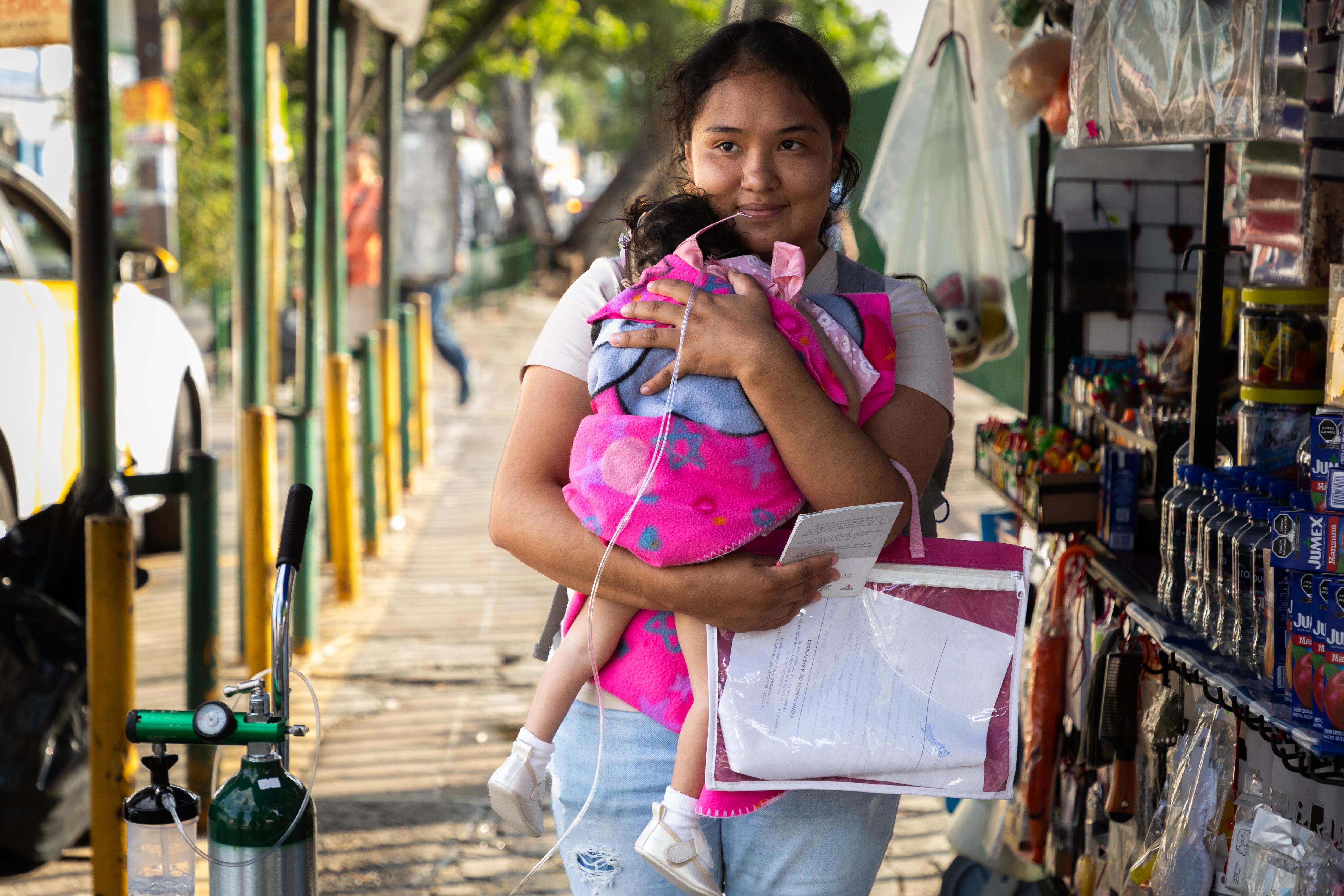 Jaqueline Vázquez, sostiene a su hija Elizabeth Milagros.