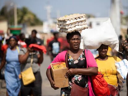 A group of women returns home after shopping on the border between Haiti and the Dominican Republic.