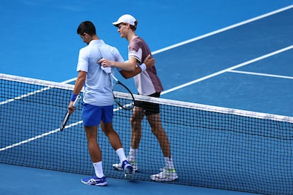 Italy's Jannik Sinner with Serbia's Novak Djokovic after winning his semi final match at Melbourne Park, Melbourne, Australia. January 26, 2024.