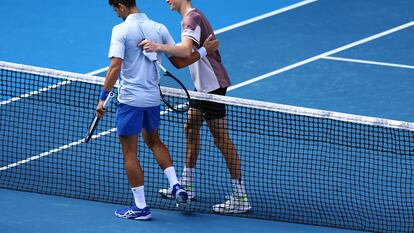 Italy's Jannik Sinner with Serbia's Novak Djokovic after winning his semi final match at Melbourne Park, Melbourne, Australia. January 26, 2024.