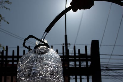 Llenado de un botellón de agua, en el marco de un corte en ocho comunas de la región Metropolitana, el 11 de octubre de 2022. JOSÉ HUMBERTO CAMPOS /AGENCIAUNO