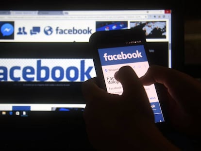 (FILES) In this file photo taken on March 22, 2018 a cellphone and a computer screen display the logo of the social networking site Facebook in Asuncion.  A US consumer protection agency said March 26, 2018 it has opened an investigation into Facebook for potentially failing to live up to its promises on privacy and possible violations of a consent decree.The Federal Trade Commission confirmed news reports from last week that it had opened an inquiry over the harvesting of Facebook data on tens of millions users of the social network by the British consulting group Cambridge Analytica.  / AFP PHOTO / NORBERTO DUARTE