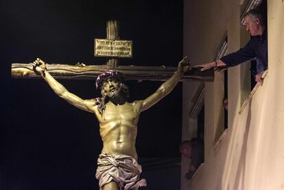 <b>MARTES SANTO. Almería.</b> Un hombre toca la imagen del Cristo del Perdón, durante su estación de penitencia.