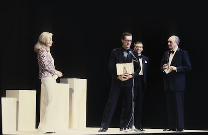 Wim Wenders with his Cannes Palme d'Or in May 1984. Faye Dunaway, Dirk Bogarde and French presenter Pierre Tchernia surround him on stage.
