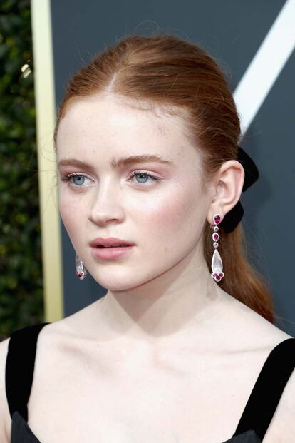 Sadie Sink recogió su melena pelirroja en una coleta con lazada.