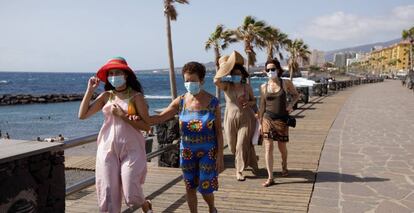 Unos turistas caminan por un paseo cercano a la playa de Las Caletillas, en el municipio de Candelaria (Tenerife). EFE/Ramón de la Rocha/Archivo