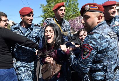 Una manifestante es detenida durante una protesta contra el partido del gobierno en Yereban (Armenia).