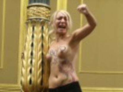 Three bare-chested Femen protestors shout slogans from spectators  gallery as justice minister speaks