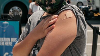 Adolescente de 13 anos recebe a primeira dose da vacina contra a covid em um bairro de Nova York, em junho.