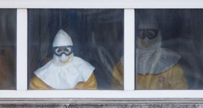 Medical staff in full protective suits treat Ebola patient Teresa Romero on the sixth floor of Carlos III Hospital in Madrid.