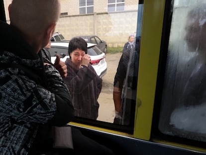 A Russian recruit, back to a camera, looks through a bus window at his mother at a military recruitment center in Volgograd, Russia, Saturday, Sept. 24, 2022. Russian President Vladimir Putin on Wednesday ordered a partial mobilization of reservists to beef up his forces in Ukraine. (AP Photo)