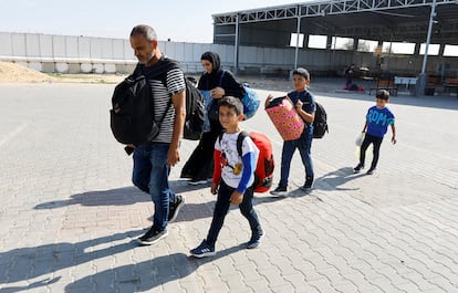 A Palestinian family with a foreign passport waits to cross the Rafah border crossing between Gaza and Egypt on November 5.