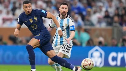 France's Kylian Mbappe and Argentina's Lionel Messi go for the ball during the World Cup final soccer match at the Lusail Stadium in Lusail, Qatar, Sunday, Dec.18, 2022.