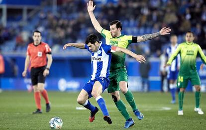 Manue García protege el balón ante Enrich.