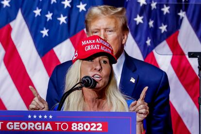 Far-right congresswoman Marjorie Taylor Greene speaks as Donald Trump looks on at the former president's rally in Rome, Georgia, last Saturday.