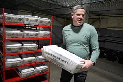 Allegheny County Election Division Deputy Manager Chet Harhut carries a container of mail-in ballots in Pittsburgh, April 18, 2024.