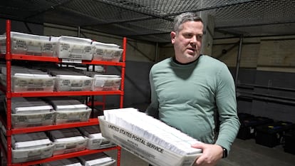 Allegheny County Election Division Deputy Manager Chet Harhut carries a container of mail-in ballots in Pittsburgh, April 18, 2024.