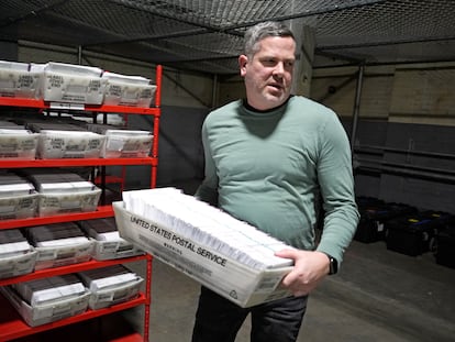 Allegheny County Election Division Deputy Manager Chet Harhut carries a container of mail-in ballots in Pittsburgh, April 18, 2024.