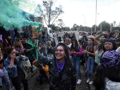 Una mujer levanta una bengala durante las manifestaciones en Bogotá, este martes 8 de marzo.