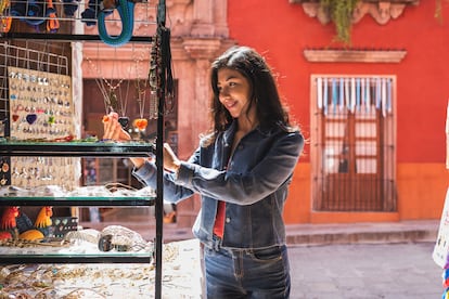 Young woman shopping for jewlery along historic street