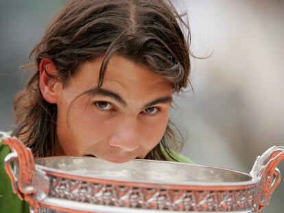 PARIS - JUNE 05:  Rafael Nadal of Spain celebrates with the trophy at the end of the Mens Final match on the fourteenth day of the French Open at Roland Garros on June 5, 2005 in Paris, France.  (Photo by Clive Mason/Getty Images)