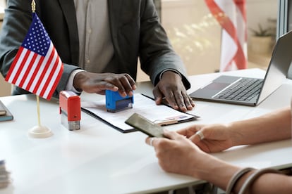 African American manager putting seals on visa document