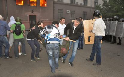 Varias personas tratan de ayudar a un manifestante pro-ruso herido en el edificio sindical en la ciudad de Odessa.