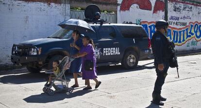 An army officer stands guard on a street in Aguililla, Michoacán.