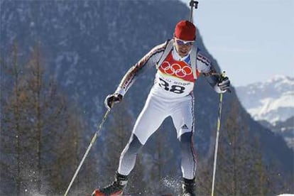 El alemán Michael Greis, fusil al hombro, asciende un repecho camino del oro en el biatlón.