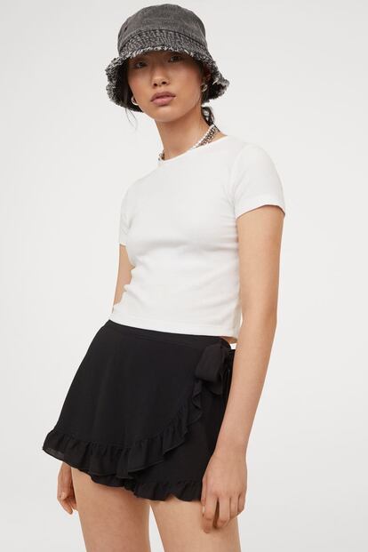 Esta falda pantalón en negro, con acabado en volante y lazada en la cintura es uno de esos básicos a precio de ganga que presumirás haber encontrado. Es de H&M y tiene un 50% de descuento, pasando a tener un precio de 9,99€