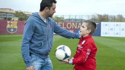 Xavi Hernández, con Pol.