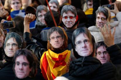 Manifestantes llevan mascaras de Carles Puigdemont durante una protesta en Barcelona.