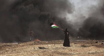 Una mujer ondea una bandera palestina durante las protestas en la Franja de Gaza.