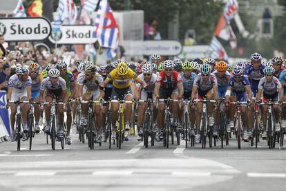 Cancellara, en el centro con el maillot amarillo, insta al pelotón a frenarse para esperar a los damnificados por las caídas de la etapa.